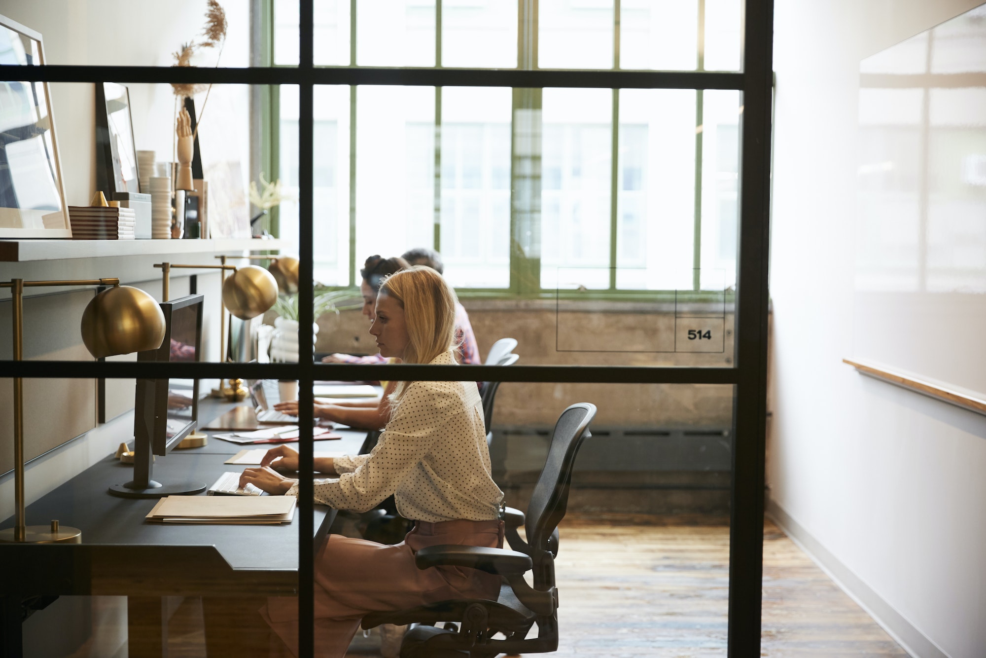 Business team working in an office booth, close up